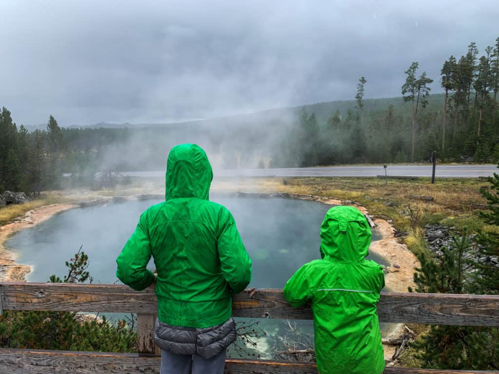 Two boys looking at springs in Fountain Paint Pot Area in Yellowstone