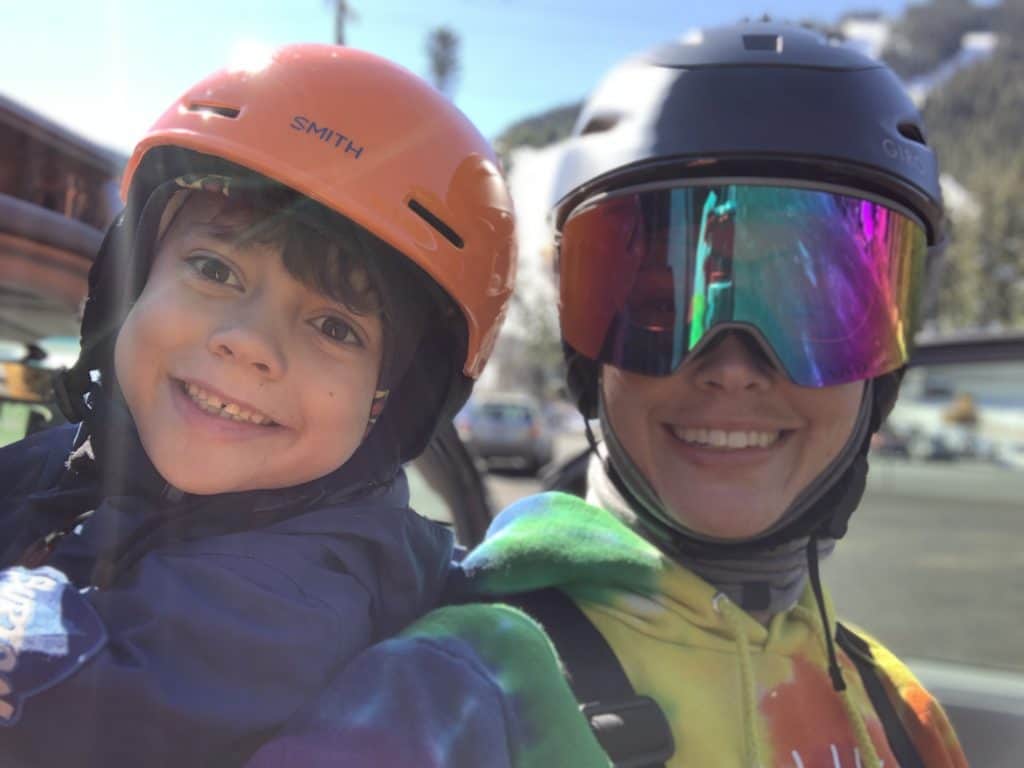 mom and son smiling after day of snowboarding