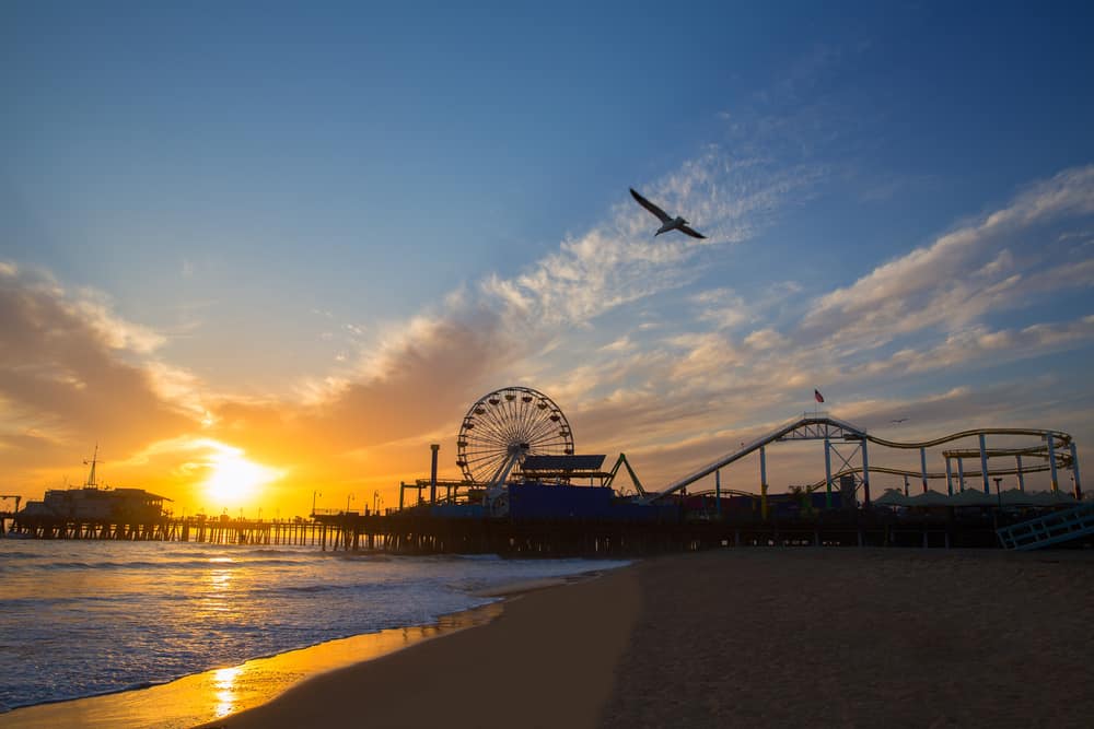 Santa Monica California sunset on Pier Ferrys wheel and reflection on beach wet sand