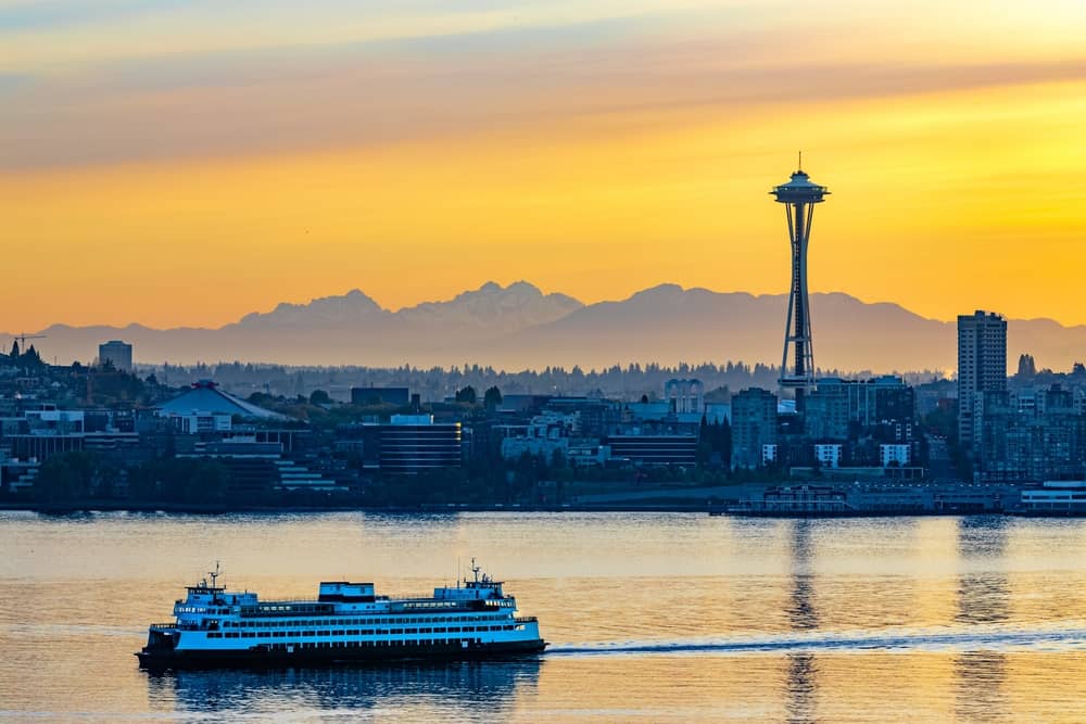 Ferry on the water with the city of Seattle, USA under the beautiful sunset in the background
