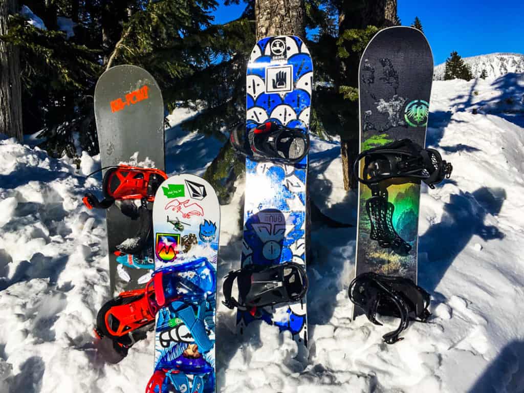 Four snowboards standing up in the snow