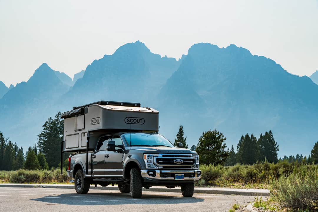 Scout Kenai Camper on Ford F350 Tremor with the Grand Tetons in the background amidst a smoky haze