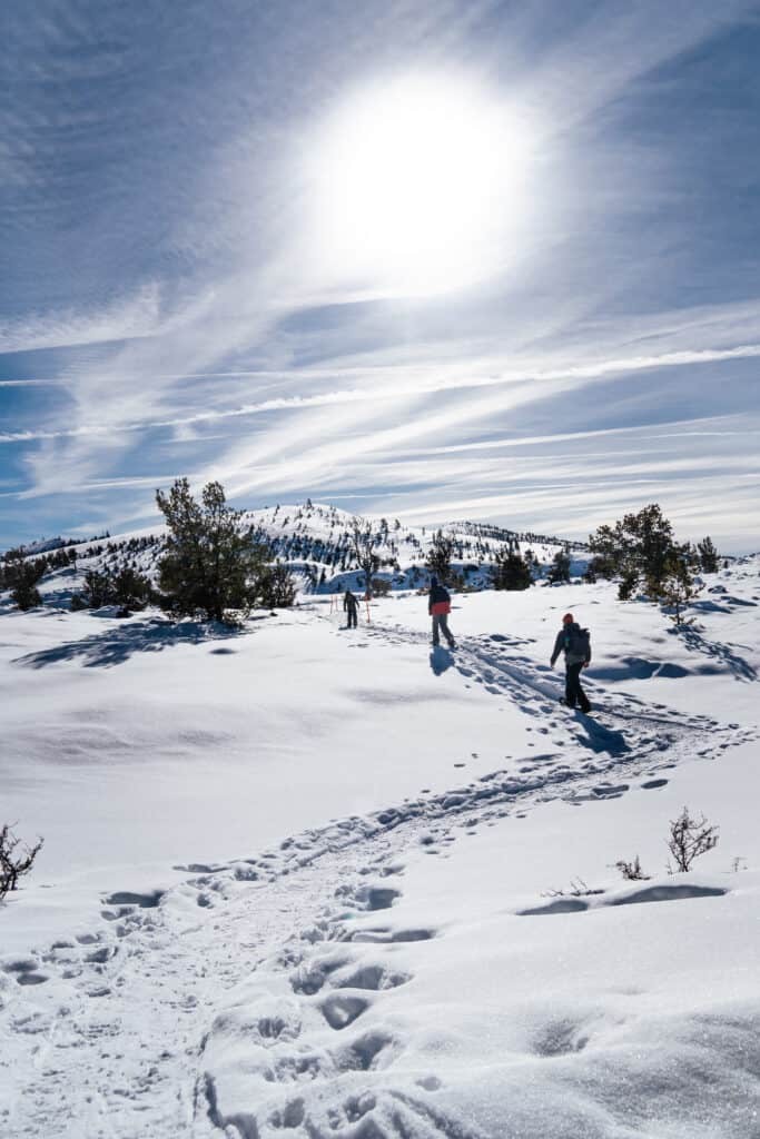 The Stoke Fam: Outdoor Adventures & Gear for the PNW & Beyond 15 father and sons snowshoe across snowy landscape of craters of the moon