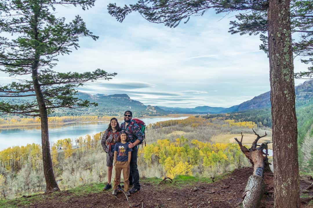 Complete Guide to Visiting Oregon’s Horsetail Falls & Ponytail Falls 7 Family of hikers standing at a scenic viewpoint along the Horsetail Falls Trail, overlooking the Columbia River Gorge with fall colors and expansive river views.