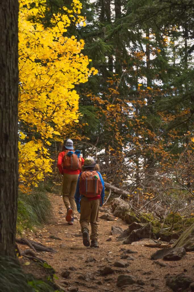 The Stoke Fam: Outdoor Adventures & Gear for the PNW & Beyond 18 two boys walk on trial in hiking shoes the fall among bright yellow leaves